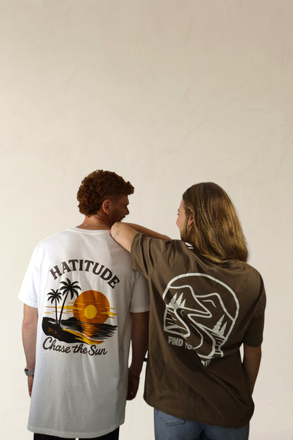 Two people wearing t-shirts with graphic designs on a plain background