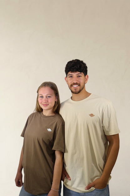 Two people wearing matching t-shirts against a plain background